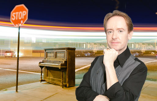 piano on street corner next to stop sign with Musiah inventor in foreground