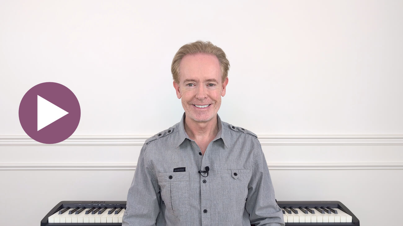 Brendan Hogan, Musiah inventor and piano teaching expert, seated with a digital piano keyboard. Click to play the Musiah welcome video