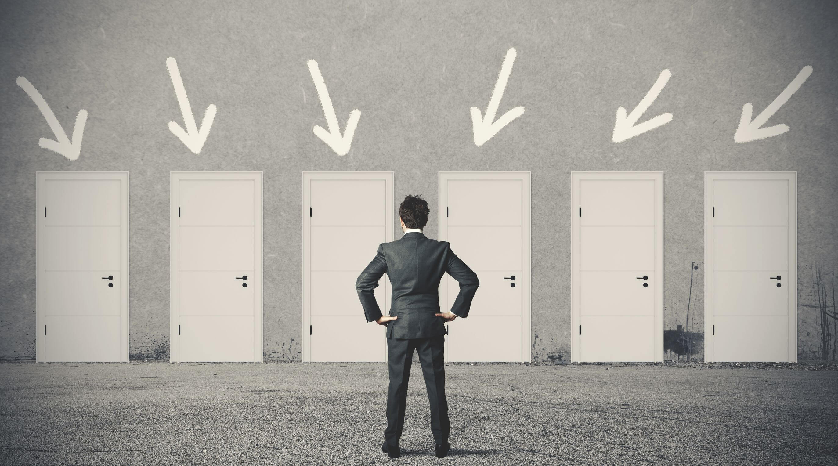 man standing in front of several doors